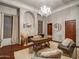 This home office offers a fireplace, chandelier, and hardwood floors at 10801 E Happy Valley Rd # 86, Scottsdale, AZ 85255