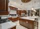 Modern kitchen featuring dark wood cabinets, stainless steel appliances, and granite countertops at 10801 E Happy Valley Rd # 86, Scottsdale, AZ 85255