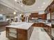Open-concept kitchen boasts a large island with seating, stainless steel appliances, and modern pendant lighting at 10801 E Happy Valley Rd # 86, Scottsdale, AZ 85255