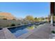 Stunning pool with mountain views surrounded by lush landscaping and privacy walls at 10801 E Happy Valley Rd # 86, Scottsdale, AZ 85255