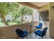 Balcony features a table with three chairs and a view of the nearby green space at 11333 N 92Nd St # 1021, Scottsdale, AZ 85260