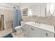 Bright bathroom featuring a walk-in shower with a blue patterned shower curtain and a vanity sink with neutral tile backsplash at 11333 N 92Nd St # 1021, Scottsdale, AZ 85260