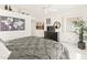 Bright bedroom features a ceiling fan, tile floors, a dresser, and an art collection displayed on the walls at 11333 N 92Nd St # 1021, Scottsdale, AZ 85260