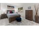 Bright bedroom features a wooden bed frame, tile floors, and natural light at 11333 N 92Nd St # 1021, Scottsdale, AZ 85260