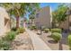 Beautifully landscaped courtyard with walking paths, mature palm trees and flowering bushes at 11333 N 92Nd St # 1021, Scottsdale, AZ 85260