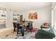 Dining area featuring a large wooden table, a decorative rug, and colorful artwork at 11333 N 92Nd St # 1021, Scottsdale, AZ 85260