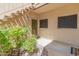 Entrance of condo showcasing the front door, green shrubs, small rocks, walkway, and a welcome mat at 11333 N 92Nd St # 1021, Scottsdale, AZ 85260