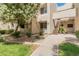 Condo exterior with desert landscaping, light-colored facade, and staircase leading to the second floor units at 11333 N 92Nd St # 1021, Scottsdale, AZ 85260