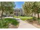 A condo exterior with green grass, trees, sidewalk, and desert landscaping on a sunny day at 11333 N 92Nd St # 1021, Scottsdale, AZ 85260