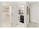 Hallway with doors to a bathroom and a walk-in closet, all with tile flooring at 11333 N 92Nd St # 1021, Scottsdale, AZ 85260