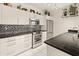 Well-lit kitchen with white cabinets, stainless steel appliances, and granite countertops at 11333 N 92Nd St # 1021, Scottsdale, AZ 85260