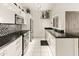 Bright kitchen featuring white cabinets, granite countertops, and stainless steel appliances at 11333 N 92Nd St # 1021, Scottsdale, AZ 85260