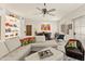 Open-concept living area with an area rug, built-in shelving, tile floors, and a modern ceiling fan at 11333 N 92Nd St # 1021, Scottsdale, AZ 85260