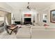 Bright living room featuring white tile floors, a fireplace, and sliding glass doors at 11333 N 92Nd St # 1021, Scottsdale, AZ 85260