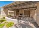 Outdoor patio with a fireplace, bench seating, stone flooring, and a lattice-covered roof at 11333 N 92Nd St # 1021, Scottsdale, AZ 85260