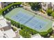 Aerial view of a tennis court, showing people playing tennis surrounded by shrubs and residential condos at 11333 N 92Nd St # 1021, Scottsdale, AZ 85260