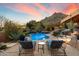 Inviting backyard pool and patio area with stunning desert mountain views at sunset at 11409 E Juan Tabo Rd, Scottsdale, AZ 85255