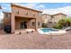 Backyard featuring a small pool with rock landscaping and a covered patio connected to the home at 17358 N 185Th Ln, Surprise, AZ 85374