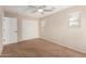 Neutral bedroom with a ceiling fan, closet, and natural light from the windows at 17358 N 185Th Ln, Surprise, AZ 85374