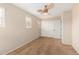 Neutral bedroom with ceiling fan, multiple windows, and closet for storage at 17358 N 185Th Ln, Surprise, AZ 85374