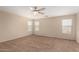 Bright bedroom features a ceiling fan and multiple windows for natural light at 17358 N 185Th Ln, Surprise, AZ 85374