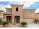 Charming two-story home featuring a unique architectural style with a tiled roof and a well-maintained front yard at 17358 N 185Th Ln, Surprise, AZ 85374