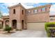 Charming two-story home with a desert landscape, tile roof, and attached two-car garage at 17358 N 185Th Ln, Surprise, AZ 85374