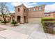 Exterior of home showcases neutral stucco, arched entryways, tile roof and mature landscaping at 17358 N 185Th Ln, Surprise, AZ 85374