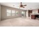 Open concept living room with carpet floors, backyard access, and a seamless transition to the kitchen at 17358 N 185Th Ln, Surprise, AZ 85374