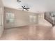 Spacious living room with tile floors, natural light, a ceiling fan, and staircase to the upper level at 17358 N 185Th Ln, Surprise, AZ 85374