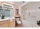 Well-lit bathroom with a vanity, bathtub, and toilet at 17443 N 99Th N Dr, Sun City, AZ 85373
