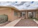 Inviting home entrance with rock garden and table with chairs in covered space at 17443 N 99Th N Dr, Sun City, AZ 85373