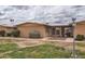 Charming single-story home features a well-maintained lawn, shrubs, and inviting facade in a quiet neighborhood at 17443 N 99Th N Dr, Sun City, AZ 85373