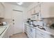 Practical kitchen with white appliances and cabinetry, designed for efficiency and functionality at 17443 N 99Th N Dr, Sun City, AZ 85373