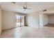 Open living room with tile flooring and sliding glass doors leading to the outdoor patio at 17443 N 99Th N Dr, Sun City, AZ 85373
