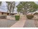 Charming community entrance to Ribbon Court with lush greenery at 17443 N 99Th N Dr, Sun City, AZ 85373