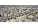 A broad aerial shot showcases a sprawling residential area, highlighting numerous homes and connecting roadways at 18856 N Comet Trl, Maricopa, AZ 85138