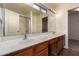 Bathroom with double sinks, large mirror, and combination shower/tub at 18856 N Comet Trl, Maricopa, AZ 85138