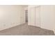 Cozy bedroom with neutral carpet and closet at 18856 N Comet Trl, Maricopa, AZ 85138