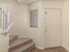 Inviting entryway with carpeted stairs and a white door with a brass knob at 18856 N Comet Trl, Maricopa, AZ 85138