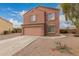 Two story home featuring a two car garage, shutters, landscaped yard, and concrete driveway at 18856 N Comet Trl, Maricopa, AZ 85138