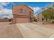 Two story home featuring a two car garage, shutters, landscaped yard, and concrete driveway at 18856 N Comet Trl, Maricopa, AZ 85138