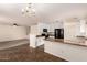 Open concept kitchen and dining area with white cabinets and track lighting at 18856 N Comet Trl, Maricopa, AZ 85138