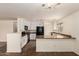 Modern kitchen with granite counters, white cabinets, tile floor, and modern appliances at 18856 N Comet Trl, Maricopa, AZ 85138