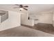 Open concept living room and dining area, featuring tile and carpet flooring at 18856 N Comet Trl, Maricopa, AZ 85138