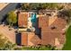 Aerial view of a home featuring a pool, patio, and tile roof, surrounded by desert landscaping at 18886 N 101St Way, Scottsdale, AZ 85255