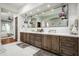 Modern bathroom featuring double sinks, granite counters, framed mirrors, and decorative pendant lights at 18886 N 101St Way, Scottsdale, AZ 85255