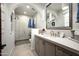 Stylish bathroom showcasing a vanity with a framed mirror, modern fixtures, and a glass-enclosed shower at 18886 N 101St Way, Scottsdale, AZ 85255