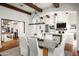 Bright dining area adjacent to the kitchen and living room with beamed ceilings at 18886 N 101St Way, Scottsdale, AZ 85255