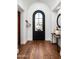 Elegant entryway featuring a black door with glass and a wooden floor at 18886 N 101St Way, Scottsdale, AZ 85255